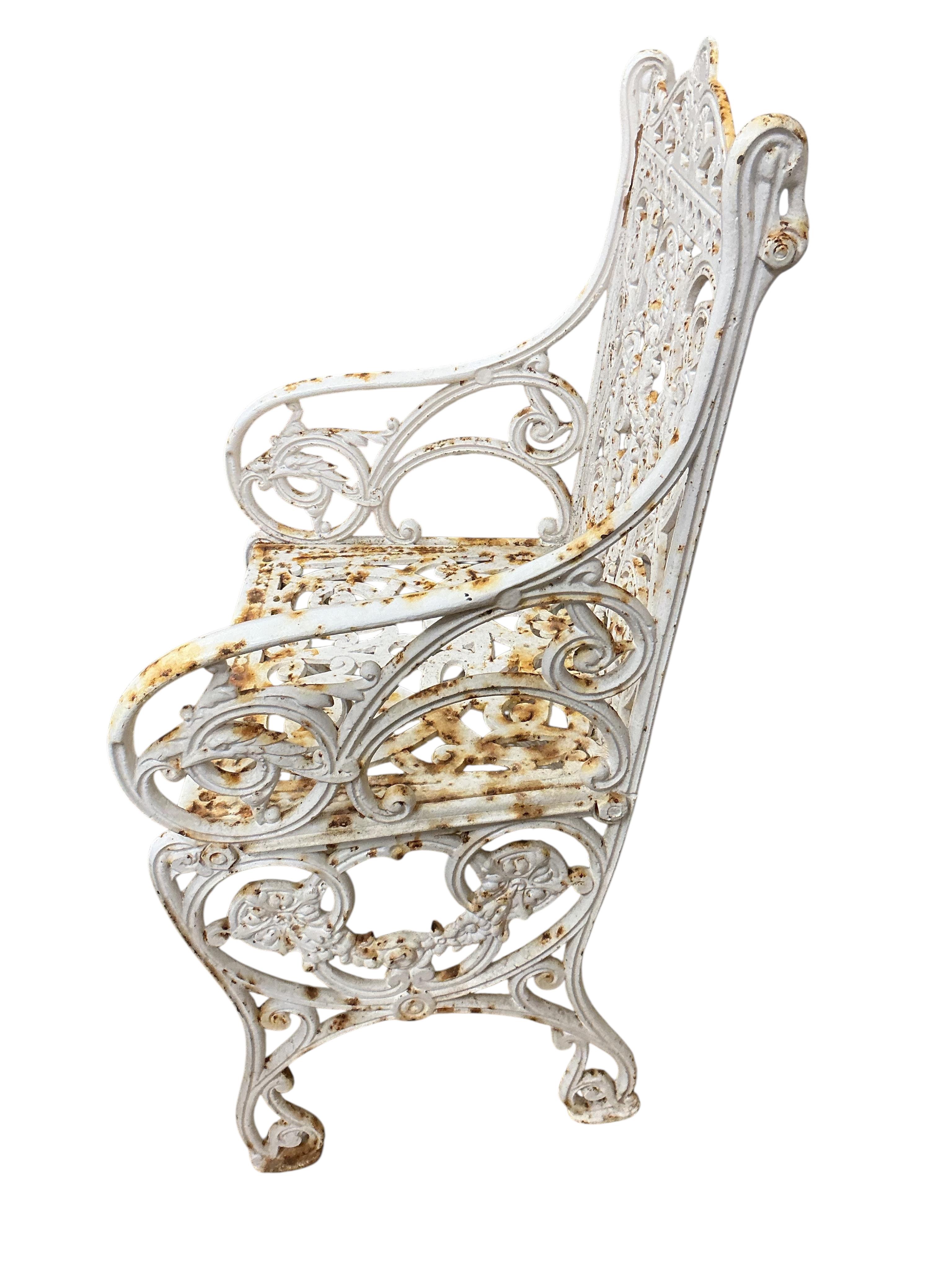 A Victorian Coalbrookdale style painted cast iron garden elbow chair, width 46cm, depth 38cm, height 88cm